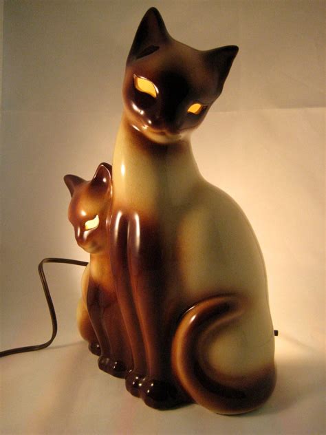 Today I am listing this great vintage tv lamp made by Lane & Co, Van Nuys, Ca. in 1958. The lamp is two large siamese cats with big blue jeweled eyes. No cracks, chips or repairs. Heavy piece. Marked